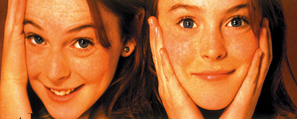 two young girl twins, faces side by side 