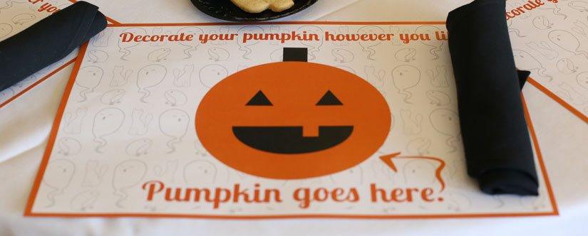 photo of placemat with cartoon pumpkin and shapes to color in
